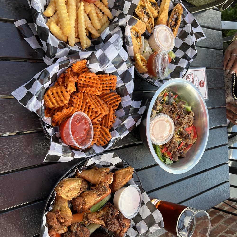 Ed's Tavern - a variety of food on a picnic table - American Near Me - Charlotte, North Carolina Ed's Tavern - a variety of food on a picnic table - American Near Me - Charlotte, North Carolina