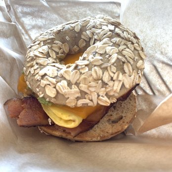 Cedar Street Bagel - Breakfast bagel with egg, cheddar cheese, avocado, bacon (on a wheat oatmeal bagel) - Bagels Near Me - Camas, Washington Cedar Street Bagel - Breakfast bagel with egg, cheddar cheese, avocado, bacon (on a wheat oatmeal bagel) - Bagels Near Me - Camas, Washington