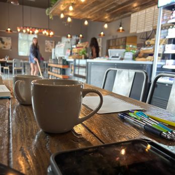 Ghost Town Coffee Roasters - a cup of coffee on a table - Coffee Roasteries Near Me - Bozeman, Montana