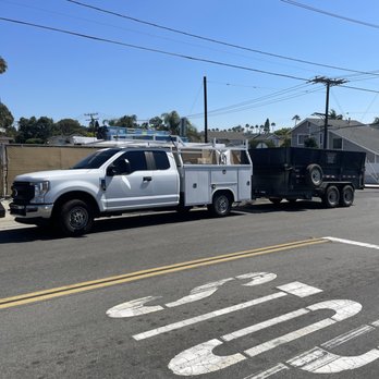 Showtime Construction - a white utility truck and a black utility truck - Excavation Services Near Me