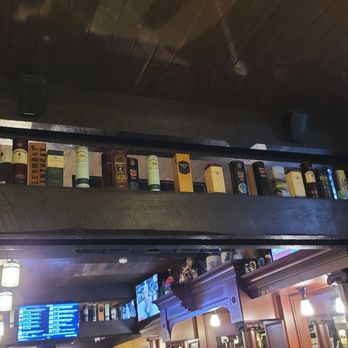 Dublin Bay Irish Pub & Grill - a bar with a lot of bottles on the shelves - American Near Me - Ames, Iowa