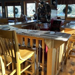 Bar seating with newspapers around old coffee equipment for aesthetic Bar seating with newspapers around old coffee equipment for aesthetic