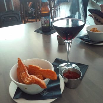 RumFish - Enjoying some sweet potato fries and a glass of wine bofore my flight. Service very friendly. Price point typical for airport prices. - Seafood Near Me - Tampa, Florida
