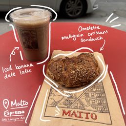 Omelette multigrain croissant sandwich, iced banana date latte Omelette multigrain croissant sandwich, iced banana date latte