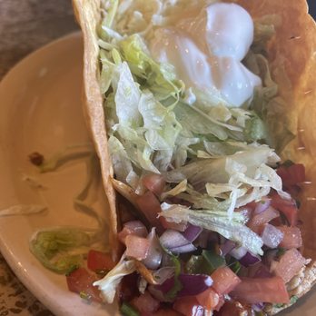 El Rodeo - Taco Salad Fajitas! - A taco salad served in a crispy taco shell, containing shredded lettuce, diced tomatoes, chopped onions, and topped with sour cream. - Mexican Near Me - Clive, Iowa