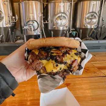 Burger Schmurger - a person holding a hot dog - Burgers Near Me - Dallas, Texas Burger Schmurger - a person holding a hot dog - Burgers Near Me - Dallas, Texas