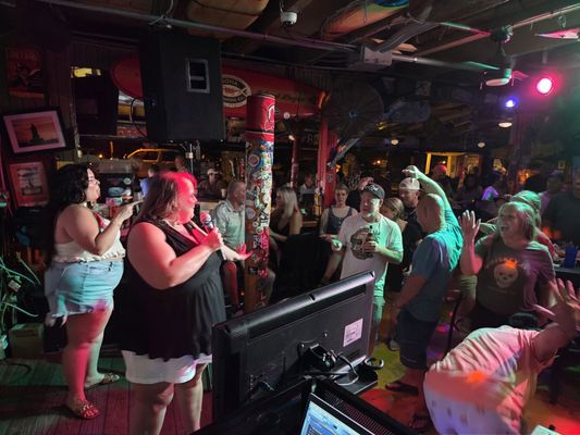 Bar & Restaurant Karaoke Nights - Make your venue the go-to spot for a great time with NuTtYBuG KaRaOkE’s full-service karaoke nights. We provide high-quality equipment, hassle-free setup, and energetic hosts who know how to keep crowds engaged and entertained. Our team works with your schedule to create nights that draw a loyal crowd, increase guest participation, and boost business. Whether it’s a weekly event or a special celebration, we turn every karaoke night into a memorable experience that brings guests back again and again.
Looking to see what's coming up? Follow us on Facebook. Bar & Restaurant Karaoke Nights - Make your venue the go-to spot for a great time with NuTtYBuG KaRaOkE’s full-service karaoke nights. We provide high-quality equipment, hassle-free setup, and energetic hosts who know how to keep crowds engaged and entertained. Our team works with your schedule to create nights that draw a loyal crowd, increase guest participation, and boost business. Whether it’s a weekly event or a special celebration, we turn every karaoke night into a memorable experience that brings guests back again and again.
Looking to see what's coming up? Follow us on Facebook.
