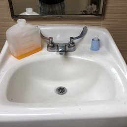 Soap dispenser broken off wall. Soap dispenser broken off wall.