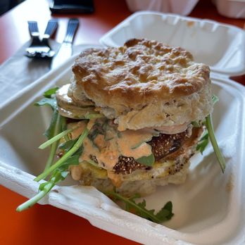 Irregardless - Fried Green Tomato on a biscuit (Fried green tomato with cheddar cheese arugula pickles and smoked tomato aioli)  Over easy egg added - Breakfast & Brunch Near Me - Providence, Rhode Island