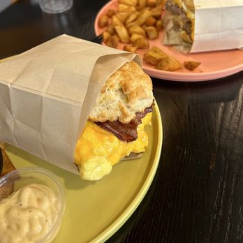 Burnt Crumbs - Bacon + egg + cheese breakfast sandwich & the sausage + egg + cheese breakfast sandwich w/ potatoes & Tabasco aioli - New American Near Me - Irvine, California