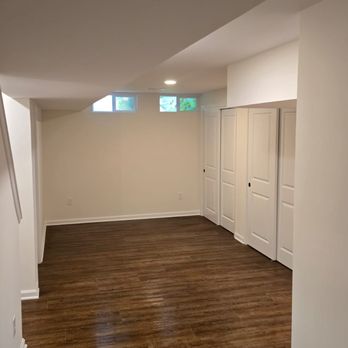 Basement Remodeling - View from wet bar - storage closets on the right. - General Contractors Near Me