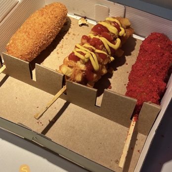 Mochinut Newark - Left: Original w/ mozzarella, Middle: Potato w/ hot dog, Right: Flaming Hot Cheetos w/ hot dog. - Desserts Near Me - Newark, Delaware