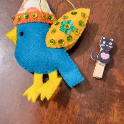 A Cat in the Attic Treasures & Treats Antiques Towne Square - Hand sewn blue bird ornament and hand made black cat clothes pic. So cute.