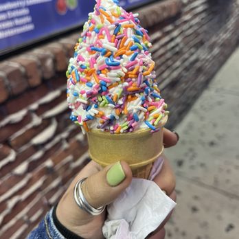Magic Fountain Ice Cream - a hand holding an ice cream cone with sprinkles - Ice Cream & Frozen Yogurt Near Me - Bayonne, New Jersey