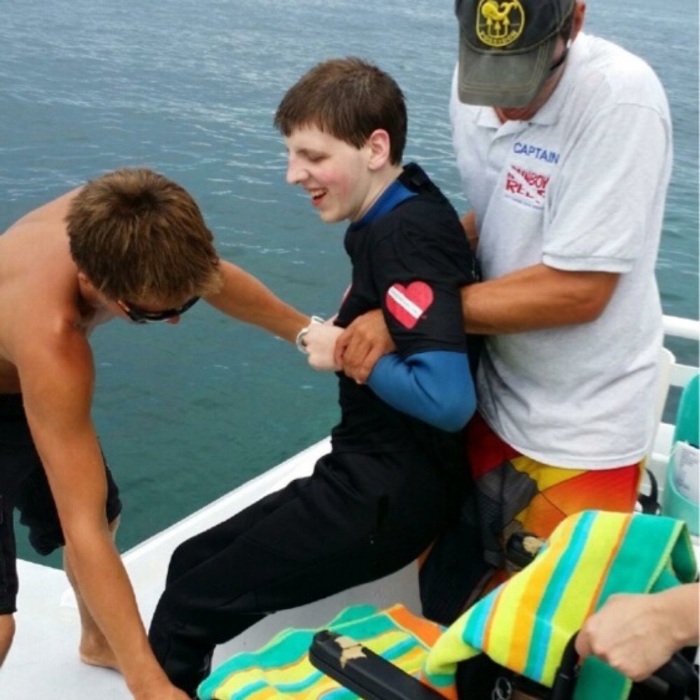 Rainbow Reef Dive Center - Captain Jordan and First Mate Brody getting Matt ready to dive. - Scuba Diving Near Me - Key Largo, Florida