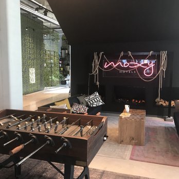 Moxy Amsterdam Houthavens - Lobby fireplace and foosball - Hotels Near Me - Amsterdam, New Hampshire