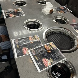 Grill and hotpot stations at the large tables