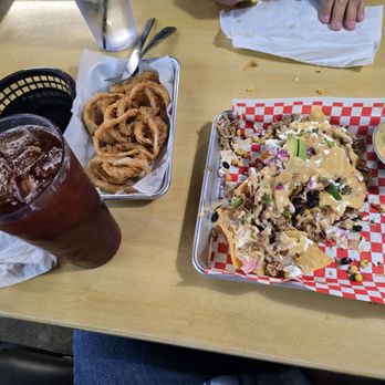 It's Nacho Average Bar & Grill - Carnitas nachos, sorry we dug in deep before the picture,  excellent!!! - Sports Bars Near Me - Midlothian, Texas