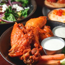 Flying Saucer Draught Emporium - Classic Wings tossed in buffalo sauce and served with your choice of ranch or blue cheese.