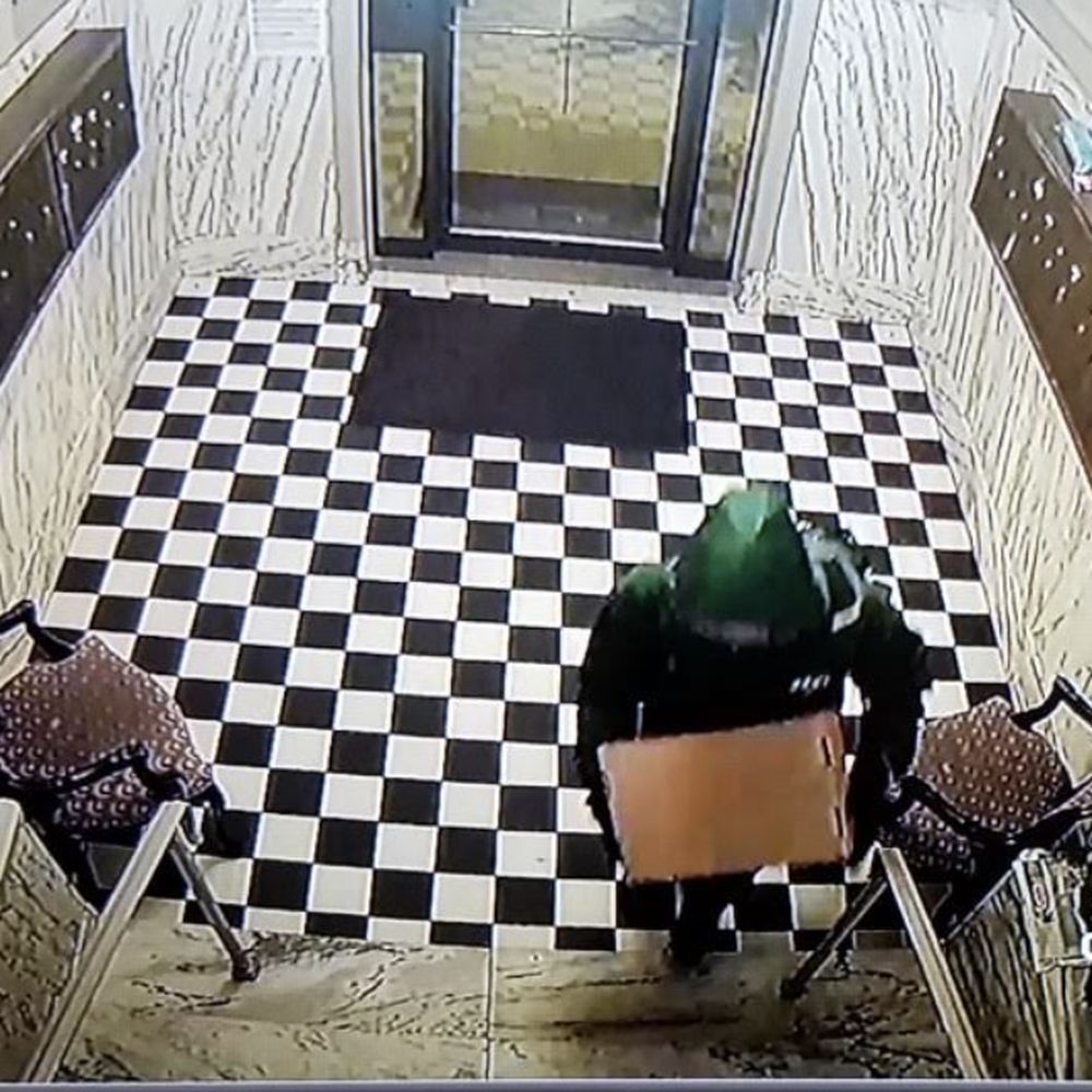 EJF Real Estate Services - Thief stealing my package from building's lobby; likely a resident, as the person enters from the hallway and not the door to the street - Property Management Near Me - Washington, DC, District of Columbia