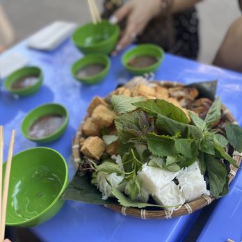 Mắm - a plate of food on a blue table - Vietnamese Near Me - New York, New York