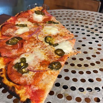 Folino's Pizza - a slice of pizza on a table - Pizza Near Me - Shelburne, Vermont Folino's Pizza - a slice of pizza on a table - Pizza Near Me - Shelburne, Vermont