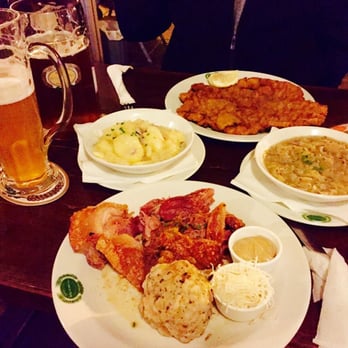 Salm Bräu - Pork knuckle in front, pork schnitzel in back served with potato salad ( bowl on the left hand side) and the cabbage (right side bowl) - Breweries Near Me - Vienna, 9