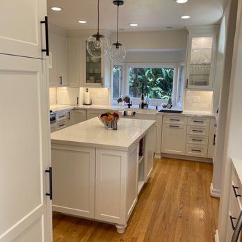 Hollywood Refinishing - a kitchen with white cabinets and wood floors - General Contractors Near Me - North Hollywood, California