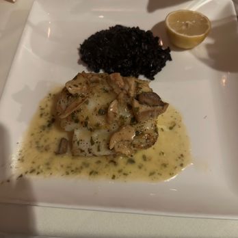 Il Terrazzo Carmine - Fish dish with lemon and black Italian rice - Italian Near Me - Seattle, Washington Il Terrazzo Carmine - Fish dish with lemon and black Italian rice - Italian Near Me - Seattle, Washington