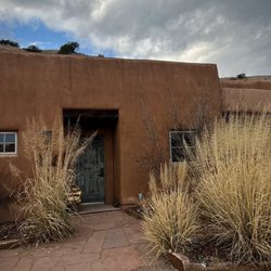 Ojo Caliente Mineral Springs Resort & Spa - Front door to our corner Cliffside Suite. Wood delivered each day of your stay.