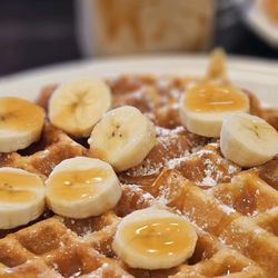 Huevo House - Belgium, waffle with fresh banana slices and caramel drizzle