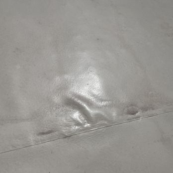 Century Roofing Specialists - Sloppy loose cheap plastic.  Supposedly had a 3/8" silicone coating that would harden stronger than concrete, but it was like bad sand - Roofing Near Me - Sanford, Florida