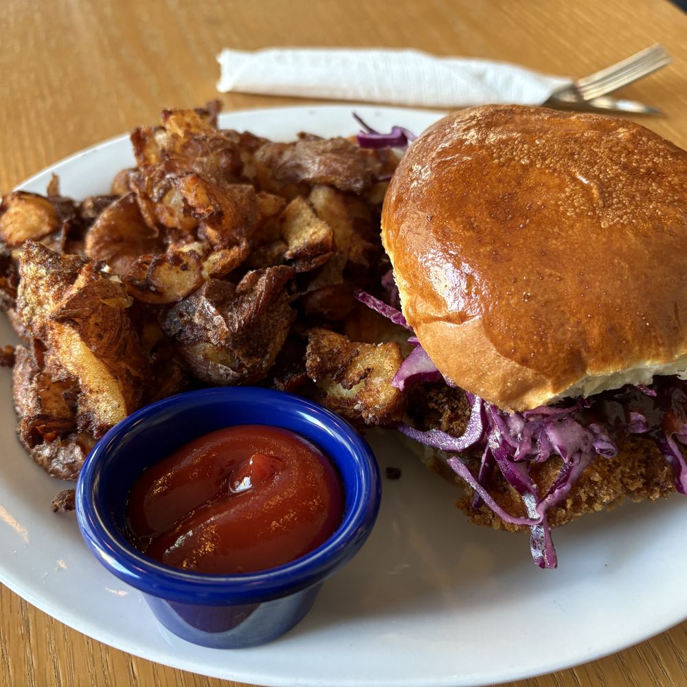 Chicken katsu sandwich and crispy potatoes. Chicken katsu sandwich and crispy potatoes.