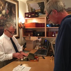 Cuban Cigar Shop - Attention to detail as the owner inspects a box of assorted Cuban robustos