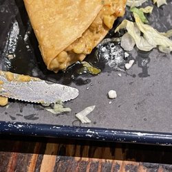 Verde - Cream corn and kale taco drenched in oil! You can see the pool of oil beneath the taco.