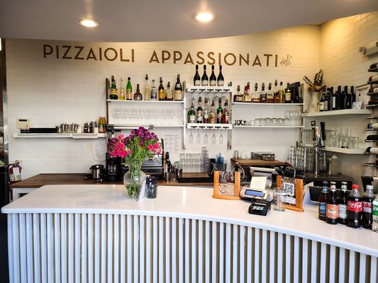 Photo of Pizzeria Omaggio - Charlotte, NC, US. interior counter with provisions