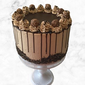 Regency Desserts - Our Chocolate Hazelnut Castle. Layers of Dark Chocolate Cake with Hazelnut Italian Meringue Buttercream, topped with a chocolate drizzle. - Cupcakes Near Me Regency Desserts - Our Chocolate Hazelnut Castle. Layers of Dark Chocolate Cake with Hazelnut Italian Meringue Buttercream, topped with a chocolate drizzle. - Cupcakes Near Me