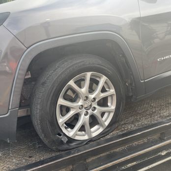 Uncle's Body Shop - [before] Blown out tire with ripped off fender liner - Body Shops Near Me - Austin, Texas