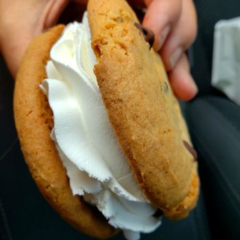 ABQ Sweet Spot - a person holding a cookie with whipped cream - Bakeries Near Me - Albuquerque, New Mexico