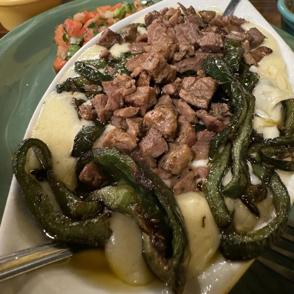 Barcenas Mexican Restaurant - Queso Flameado with Roasted Poblanos, Fajita Beef, fresh pico; and hot tortilla. - Mexican Near Me - Friendswood, Texas