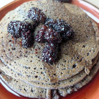 Owamni - Corncakes topped with maple and stewed blackberries - New American Near Me - Minneapolis, Minnesota