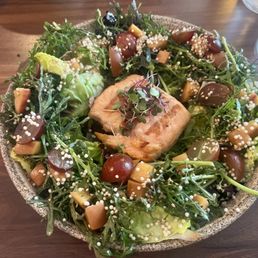 Black lentil salad with salmon add on. The lentils are hiding underneath. Black lentil salad with salmon add on. The lentils are hiding underneath.