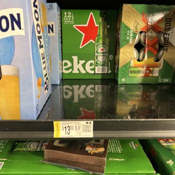 Walmart Supercenter - Walmart at Clovis New Mexico - Heineken beer packs are shown on a store shelf, including a 12-pack box and a multi-pack with cans. A clearance price tag indicates $13.00. - Grocery Near Me - Clovis, New Mexico