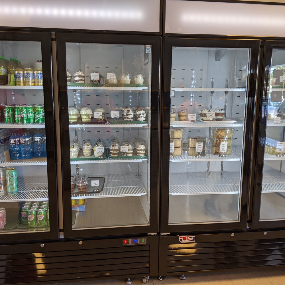 Rolls Village - Inside. Refrigerators holding beverages (canned and bottled) and a variety of cakes and other cold desserts. - Bakeries Near Me - Chamblee, Georgia Rolls Village - Inside. Refrigerators holding beverages (canned and bottled) and a variety of cakes and other cold desserts. - Bakeries Near Me - Chamblee, Georgia