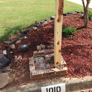 HJC Construction - a fire hydrant in the middle of a flower bed - General Contractors Near Me