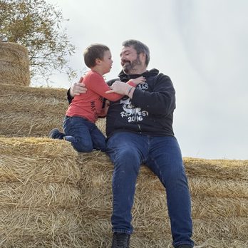 Center Grove Orchard - Playing on the hay stack - Botanical Gardens Near Me - Cambridge, Iowa Center Grove Orchard - Playing on the hay stack - Botanical Gardens Near Me - Cambridge, Iowa