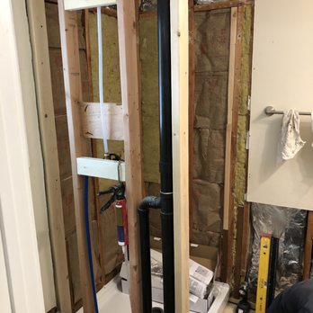 MJB Construction Services - a man working in a bathroom - General Contractors Near Me - Woodinville, Washington