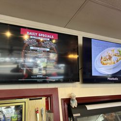 Milano's Pizza & Deli - Menu board