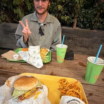 Plant Power Fast Food - I got a ''Bacon' Cheeseburger, curly fries,and my friend got a Iconic Burger and regular fries - Vegan Near Me - Encinitas, California