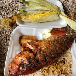 Red snapper with rice and peas, cabbage, plantains, and roasted corn.